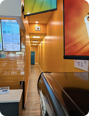 Interior of a Jones Shakes store with the menu screens