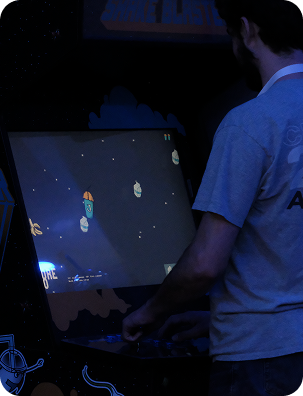 Customer playing the Shake Blaster arcade game in the store