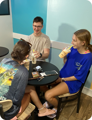 Two friends sitting with their milkshakes